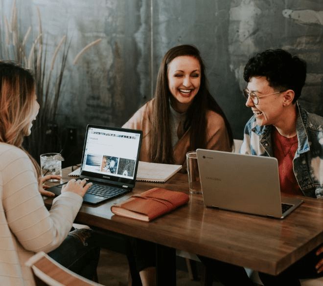 A small team working through a plan together around a table
